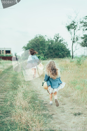 Image of The young mother and daughter on green grass background 