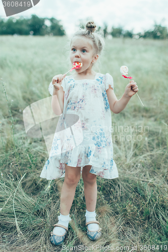 Image of The young girl on green grass background 