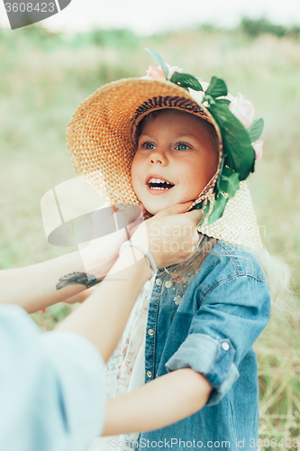 Image of The young mother and daughter on green grass background 