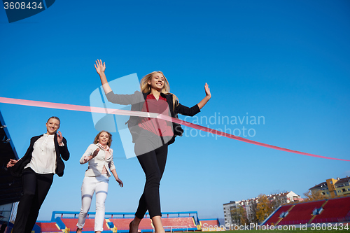 Image of business people running on racing track