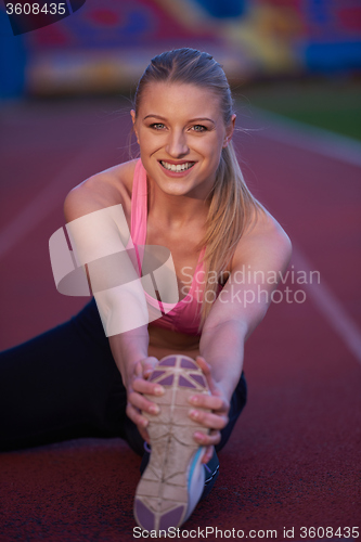 Image of sporty woman on athletic race track