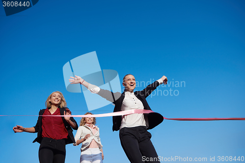 Image of business people running on racing track