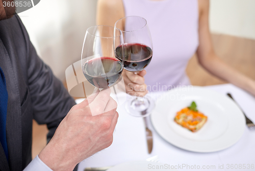Image of young couple with glasses of wine at restaurant