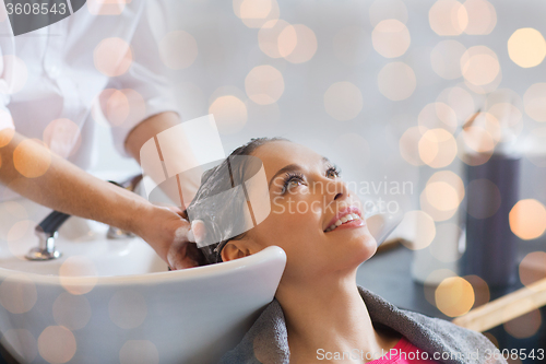 Image of happy young woman at hair salon