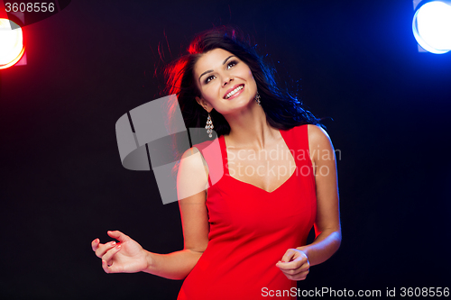 Image of beautiful sexy woman in red dancing at nightclub