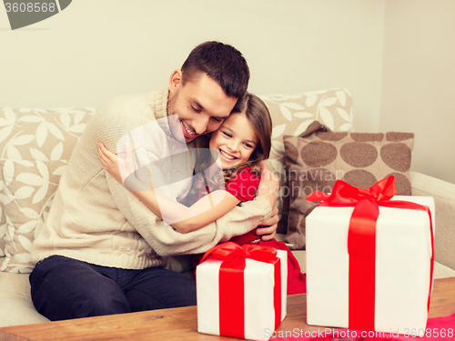 Image of smiling father and daughter hugging