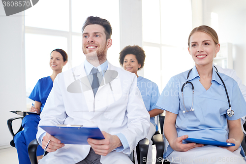 Image of group of happy doctors on seminar at hospital