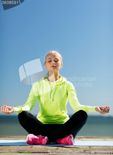 Image of woman doing yoga outdoors