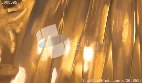 Image of lights reflection on golden metallic background