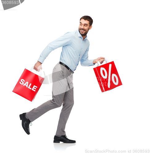 Image of smiling man with red shopping bag