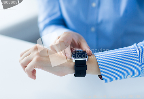 Image of close up of hands setting smart watch