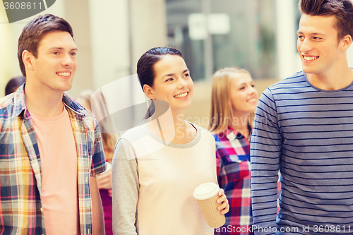 Image of group of smiling students with paper coffee cups