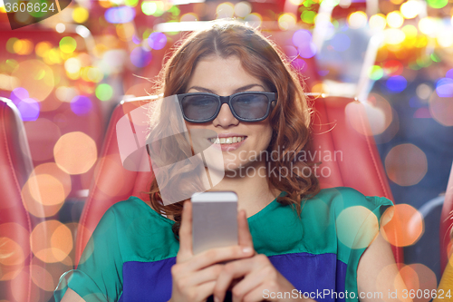 Image of happy woman with smartphone in 3d movie theater