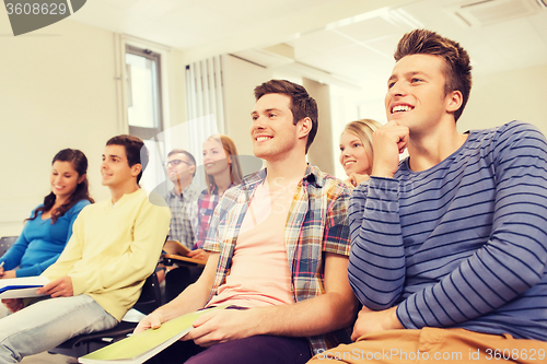 Image of group of smiling students in lecture hall