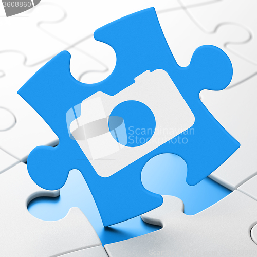 Image of Tourism concept: Photo Camera on puzzle background