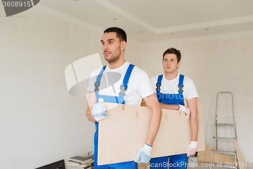 Image of group of builders with wooden boards