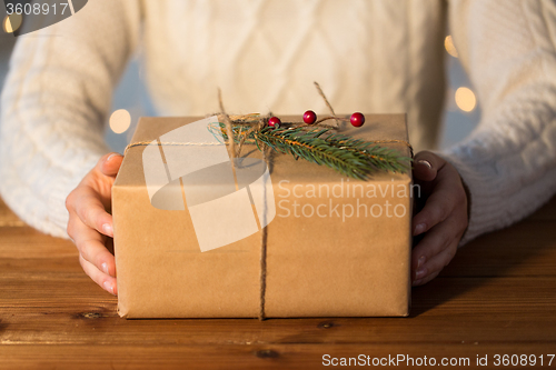 Image of close up of woman with christmas gift or parcel