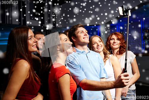 Image of friends with smartphone taking selfie in club