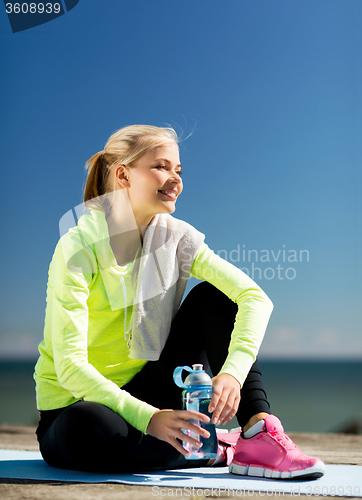 Image of woman resting after doing sports outdoors