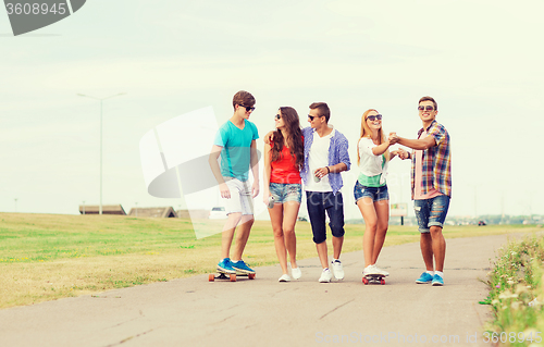 Image of group of smiling teenagers with skateboards