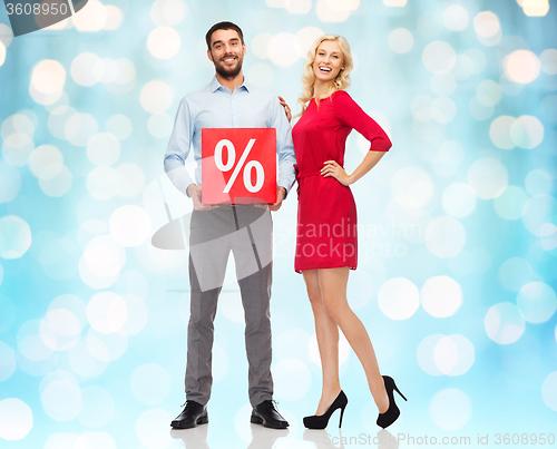 Image of happy couple with red sale sign over lights