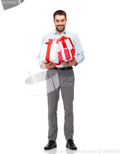 Image of happy young man holding gift boxes