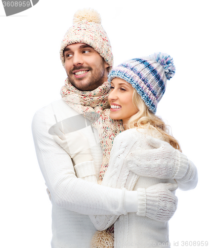 Image of smiling couple in winter clothes hugging