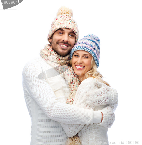 Image of smiling couple in winter clothes hugging