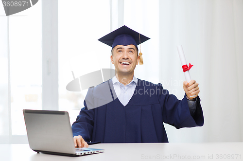 Image of smiling adult student in mortarboard with diploma