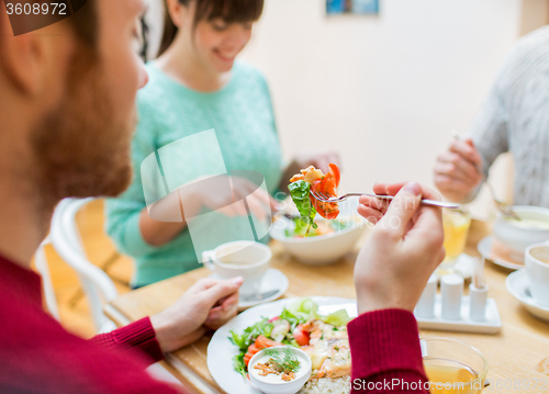 Image of close up friends having dinner at restaurant