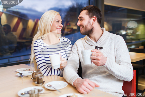 Image of happy couple meeting and drinking tea or coffee