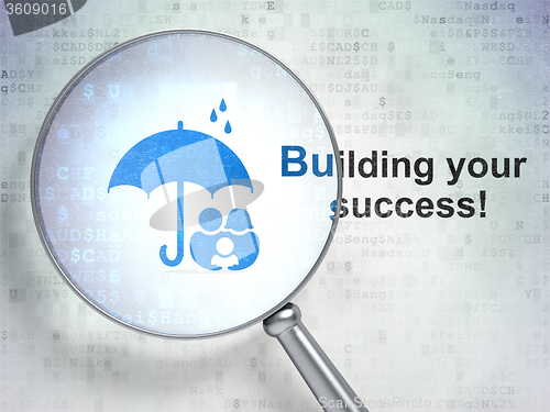 Image of Business concept: Family And Umbrella and Building your Success! with optical glass