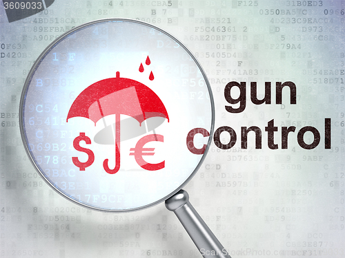 Image of Protection concept: Money And Umbrella and Gun Control with optical glass