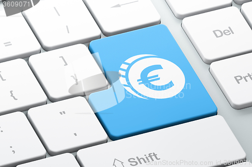 Image of Currency concept: Euro Coin on computer keyboard background
