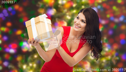 Image of beautiful sexy woman in red dress with gift box