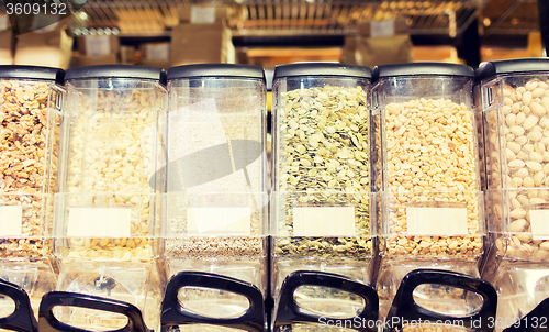 Image of row of jars with nuts and seeds at grocery store