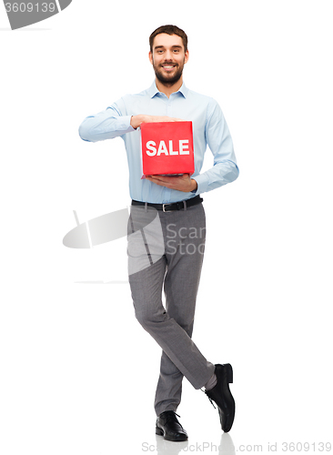 Image of smiling man with red shopping bag