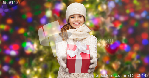 Image of girl in hat, muffler and gloves with gift box