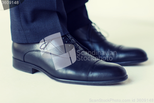 Image of close up of man legs in elegant shoes with laces