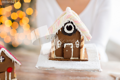 Image of close up of woman showing gingerbread house