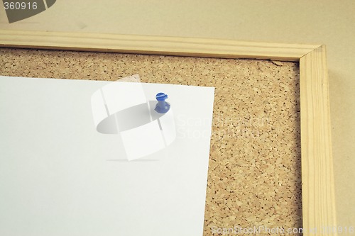 Image of white notepaper on a cork board