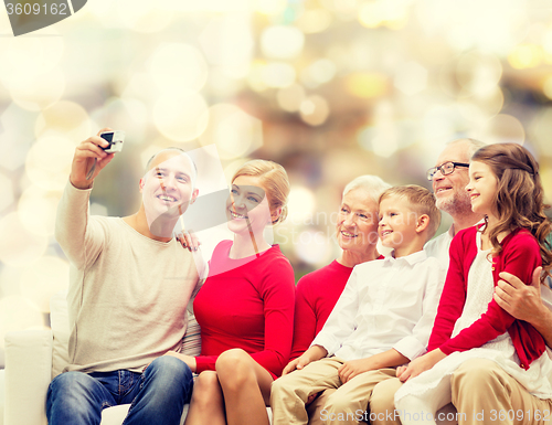 Image of smiling family with camera