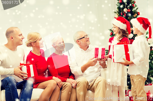 Image of smiling family with gifts at home