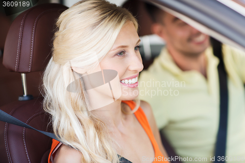 Image of happy man and woman driving car