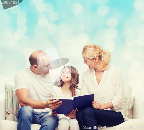 Image of happy family with book at home