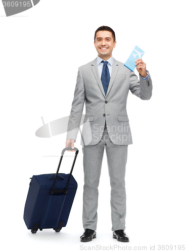 Image of happy businessman in suit with travel bag