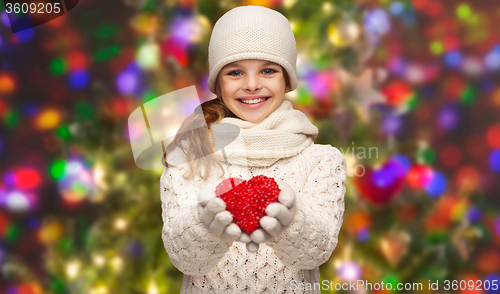 Image of girl in winter clothes with small red heart