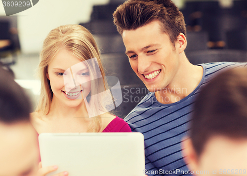 Image of group of smiling students with tablet pc