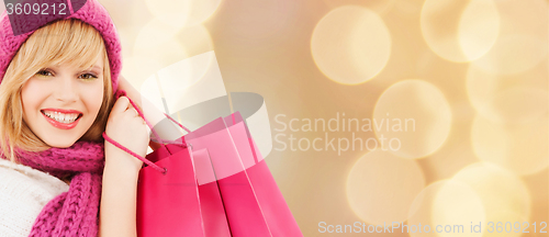 Image of smiling young woman with shopping bags