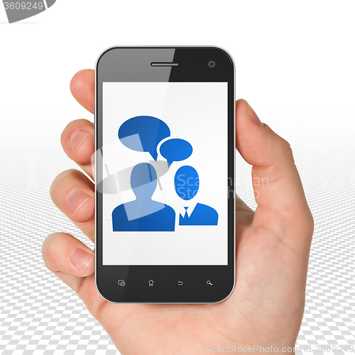 Image of Business concept: Hand Holding Smartphone with Business Meeting on display